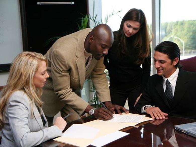 A group of business associates working around a table